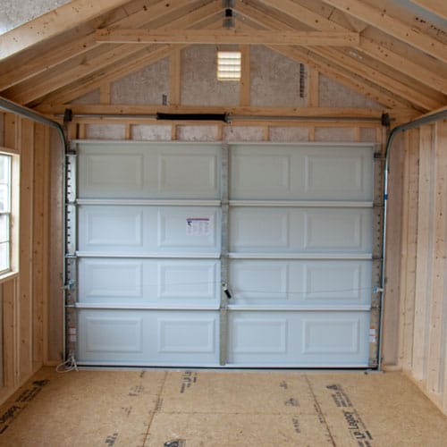 A shed garage by Westwood Sheds with a roll up door.