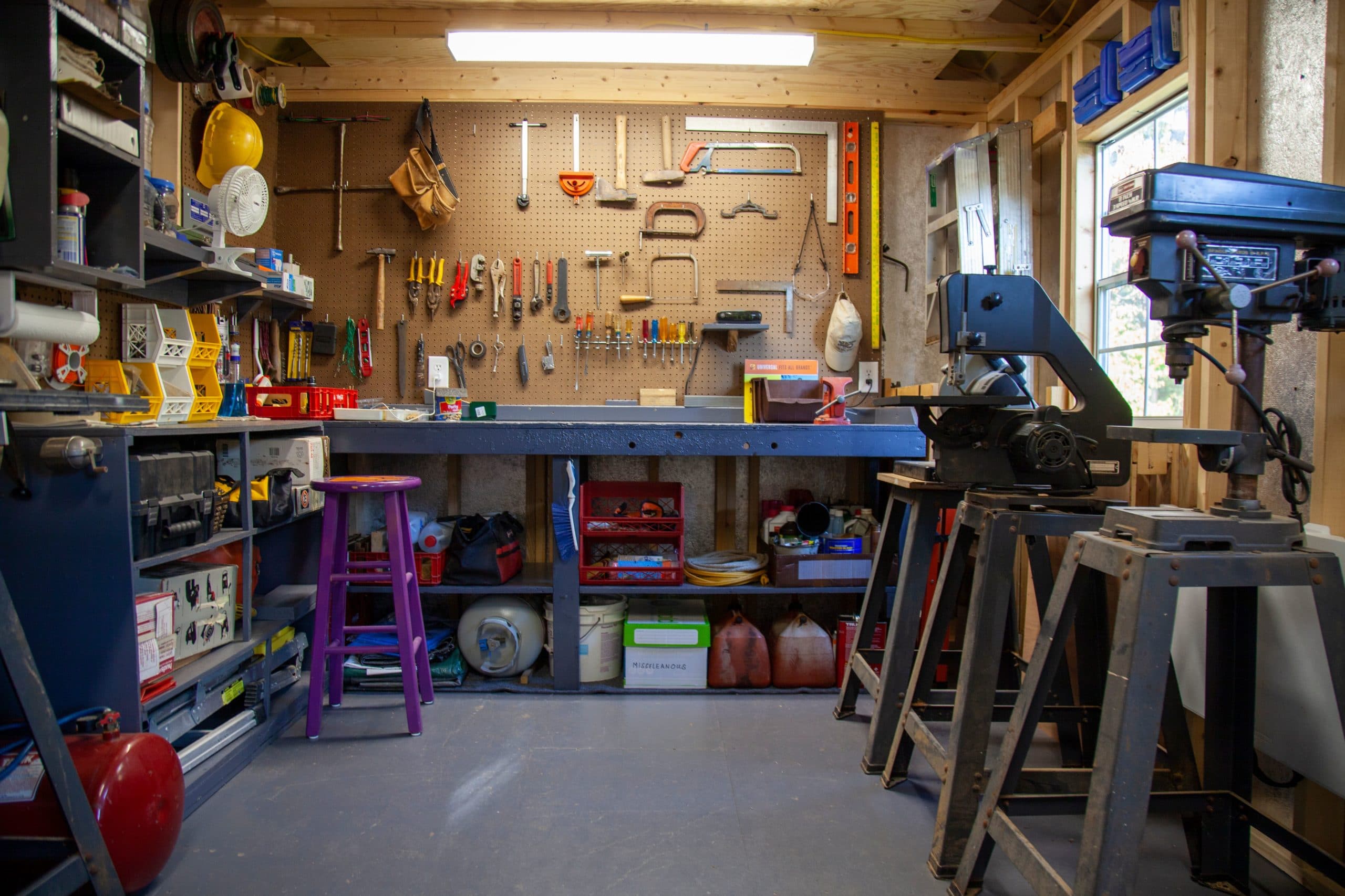 A workbench and peg board set up inside of one of Westwood Shed's outdoor buildings.